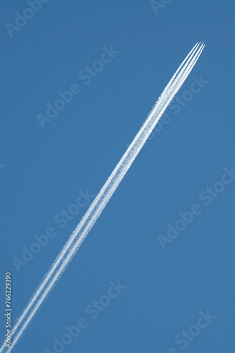 General stock image - Contrail behind an overflying aircraft. photo