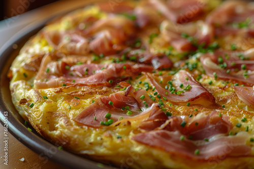 A close-up image of a plate served with a traditional Spanish tortilla (potato omelette)