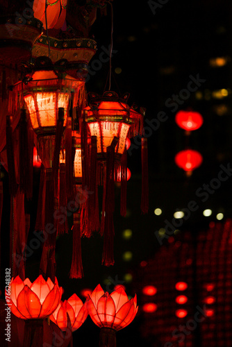 Title: A Night of Illumination

Description: Lanterns glow vibrantly against a mesmerizing backdrop of lights, creating an enchanting night scene. photo