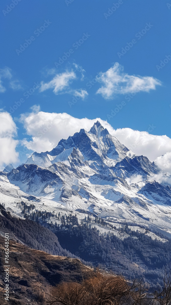 Snowcovered mountain under a blue sky with fluffy clouds on the horizon. Generative AI Snowcovered mountain under a blue sky with fluffy clouds on the horizon. Generative AI