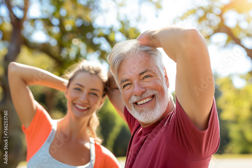 A happy senior couple enjoying outdoor fitness training together in the park,embracing the vitality of nature, A man and a woman are smiling, wearing a red shirt and orange shirt. ,happy, lighthearted