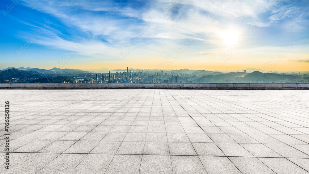 Empty square floor and modern city skyline with mountains