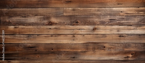 A closeup image of a hardwood brown wooden wall with a blurred background. The plank is a rectangle shape made of plywood, a building material typically used for flooring, stained in a beige color photo