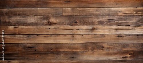 A closeup image of a hardwood brown wooden wall with a blurred background. The plank is a rectangle shape made of plywood, a building material typically used for flooring, stained in a beige color