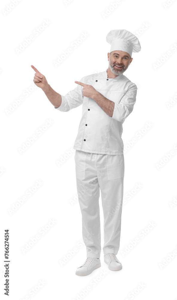 Happy chef in uniform pointing at something on white background