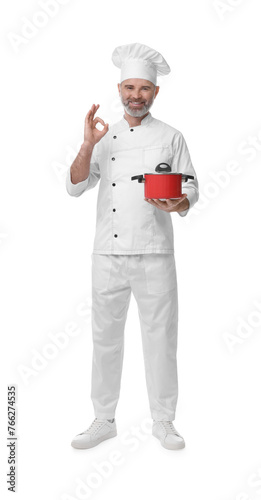 Happy chef in uniform with cooking pot showing OK gesture on white background