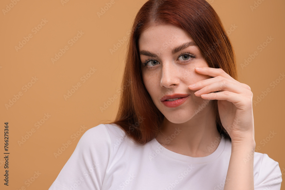 Portrait of beautiful woman with freckles on beige background. Space for text Portrait of beautiful woman with freckles on beige background. Space for text