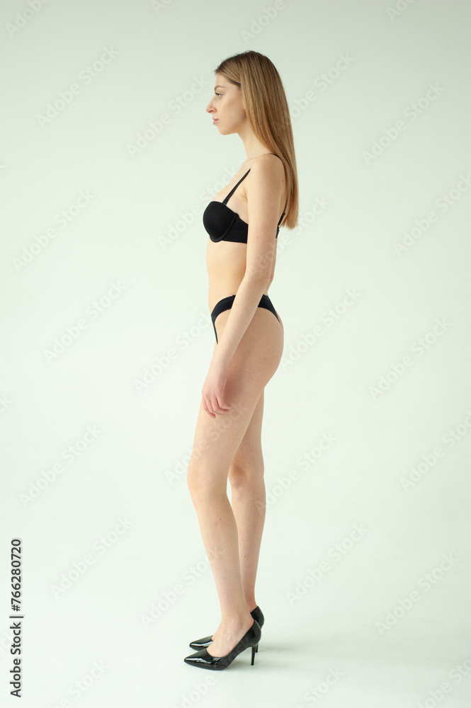 Beautiful female model . Beauty woman . Model test portrait with young beautiful fashion model posing on grey background. Beautiful female model . Beauty woman . Model test portrait with young beautiful fashion model posing on grey background.