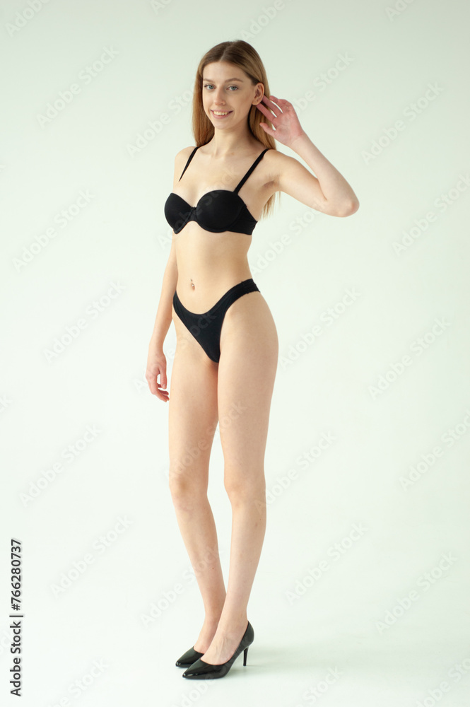Beautiful female model . Beauty woman . Model test portrait with young beautiful fashion model posing on grey background. Beautiful female model . Beauty woman . Model test portrait with young beautiful fashion model posing on grey background.