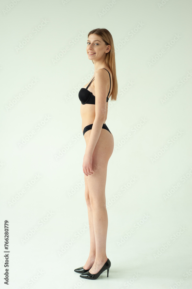 Beautiful female model . Beauty woman . Model test portrait with young beautiful fashion model posing on grey background.