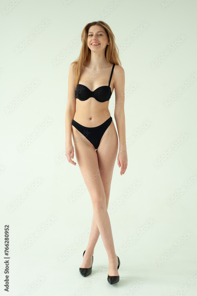 Beautiful female model . Beauty woman . Model test portrait with young beautiful fashion model posing on grey background. Beautiful female model . Beauty woman . Model test portrait with young beautiful fashion model posing on grey background.