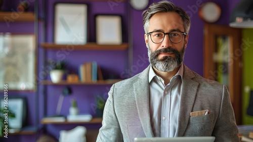 Bearded Man With Glasses Looking at Laptop