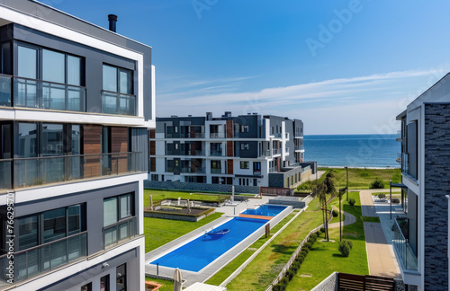 Beachfront real estate complex with three floors, apartment building near the sea