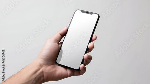 male hand holding a phone with a white screen on a gray background , smartphone with a blank, blank screen in a mans hands against white background, Hand hold smartphone. Cellphone man

