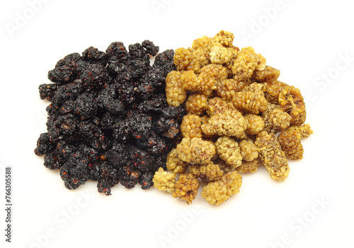 Two piles of dry mulberry isolated on white background. Black and white fruit berries