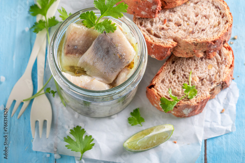 Fresh and delicious marinated herring in oil, herbs and onions.