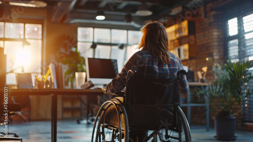 Woman in a wheelchair working in office