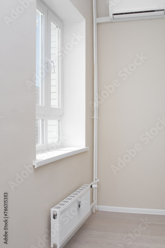 Empty light  flat with window and modern radiator