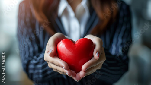 Businesswoman holding red heart in her hands  valentines day concept
