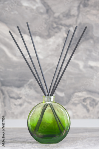 Herbal reed diffuser  close up on gray wall background
