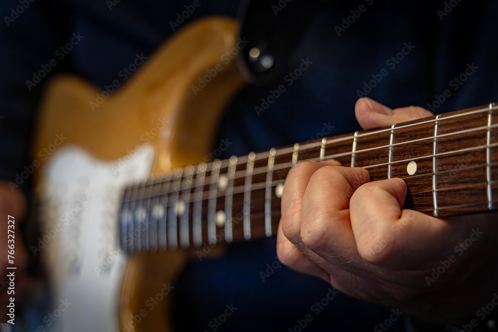 man playing electric guitar, close up