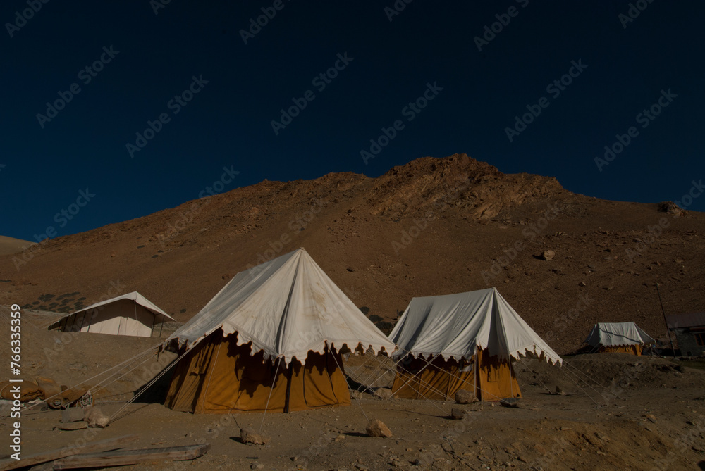 Tents at night with Himalaya mountain ranges in the background on Lake Pangong, Ladakh, India,
