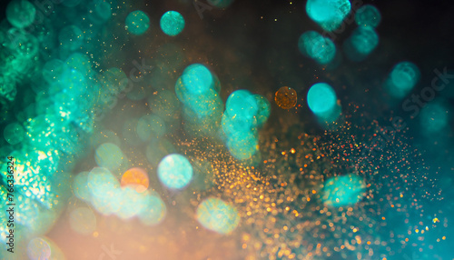 Bokeh light overlay. Blur glitter texture. Shimmering water bubbles. Defocused verdigris green blue orange color particles on dark abstract background.