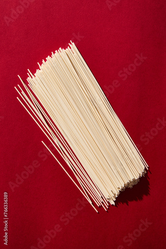 Chinese wheat noodles on red background. Retro style 80-90s food photography