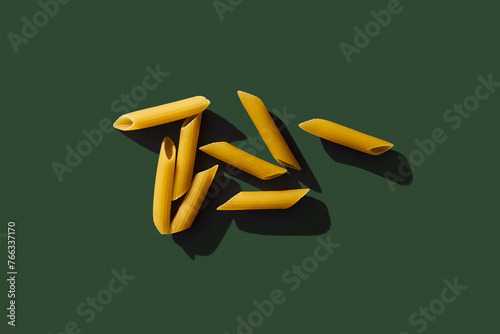 Penne pasta on blue background. Retro style food photo