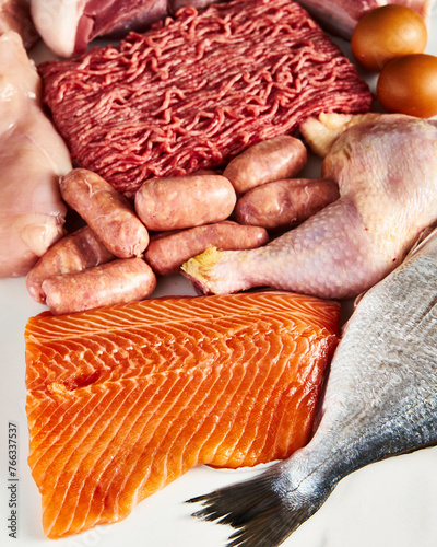Carnivore diet or low carb diet background concept. Raw animal meat products beef, minced pork and sausages, chicken with dorado fish and salmon. High protein. Top view. Close up