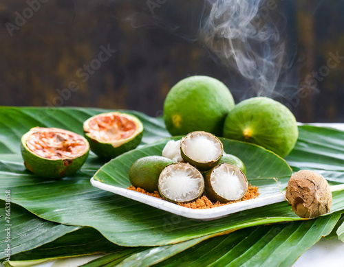 chewing betel nut, areca nut with cal lime powder on betel leaves photo