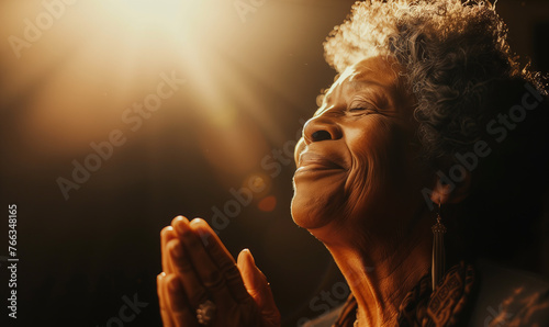 Old black christian woman praying and smiling. Faith and christianity concept.