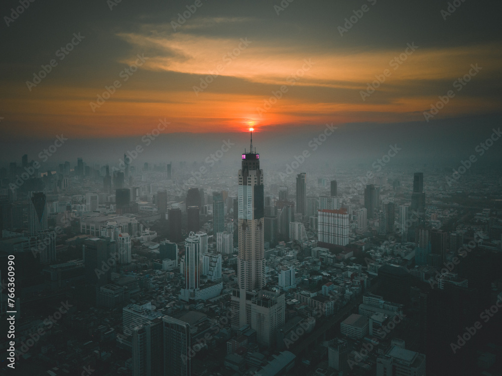 Baiyoke Sky Tower in Bangkok, Thailand during sunset. The sunset aligned with Baiyoke Sky Tower.
