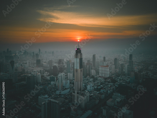 Baiyoke Sky Tower in Bangkok, Thailand during sunset. The sunset aligned with Baiyoke Sky Tower.