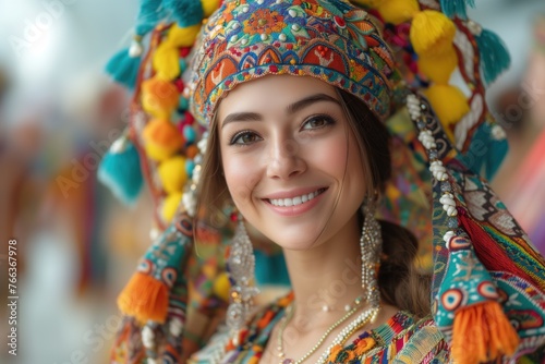 A beaming woman wearing a colorful, traditional costume adorned with floral patterns and embroidery