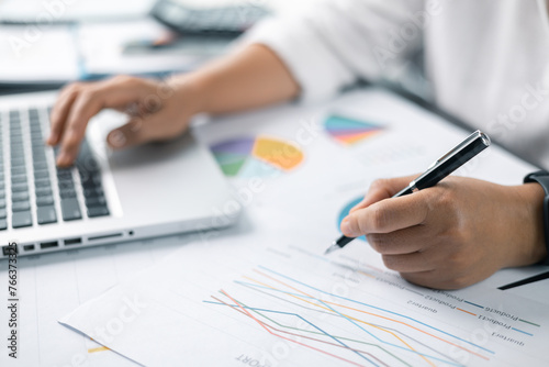 Woman analyze document in her hands. Businesswoman analyst working at office on laptop while sitting at wooden table. Business financing accounting banking concept. finance accounting.