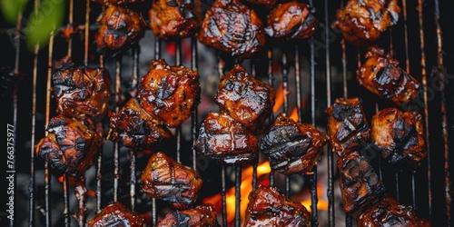 A grill full of meat with a lot of sauce on it. The meat is brown and looks delicious