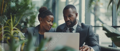 Male CEO and female partner discuss problem solving in office, while looking at laptops. Smart Businesspeople in Finance Work Together. Teamwork Concept. photo