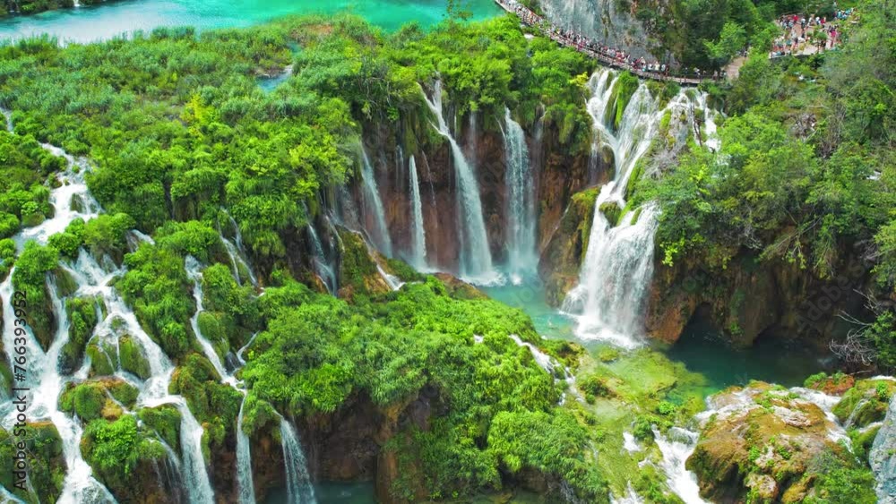 Plitvice waterfalls in Croatia. Distinct hues of blue and green can be seen in the cascades. Mountain streams flow into a lakes.