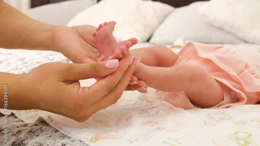 Mom gives baby a foot massage. selective focus. Mom gives baby a foot massage. selective focus.