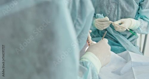 Surgeons Performing Operation with Sterile Surgical Tools photo