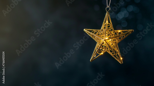  A gold star shaped hanging christmas ornament. Shallow depth of field.