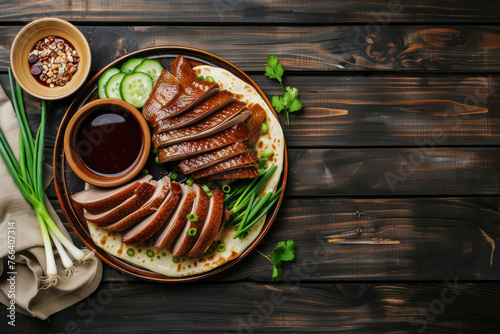 authentic peking duck served with scallions, cucumbers, and hoisin sauce on a ceramic plate photo
