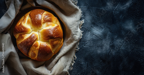 freshly baked golden brioche bread on dark textured background, free space for text