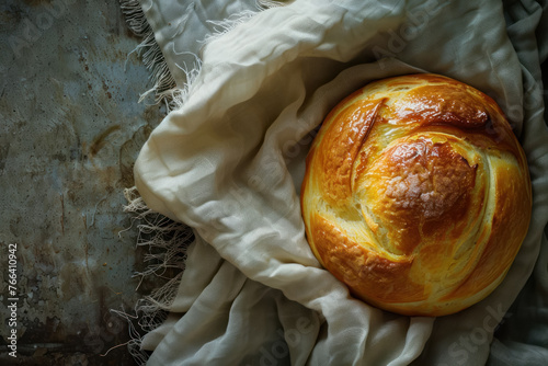 golden brown freshly baked brioche on cloth, top view  photo