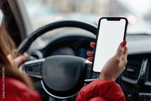 person Driver holding phone white screen on steering wheel background photo
