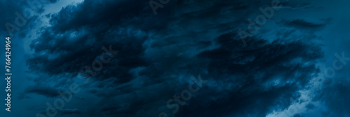 Dark blue cloudy sky before thunderstorm. Storm gloomy heaven cloudscape. Nature dramatic skyscape wide banner background