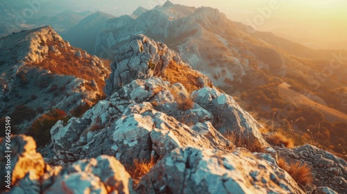 Sunset Glow on Rugged Mountain Slopes The last light of sunset bathes rugged mountain slopes in a warm glow, accentuating the rough texture and tranquil scenery. photo