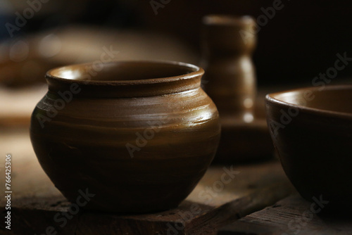 clay jug on a wooden background © Luis Martínez