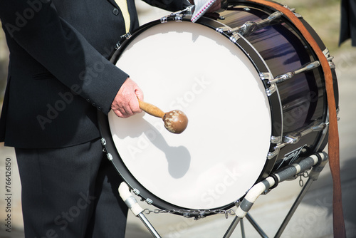 Details of hands playing the bass drum
